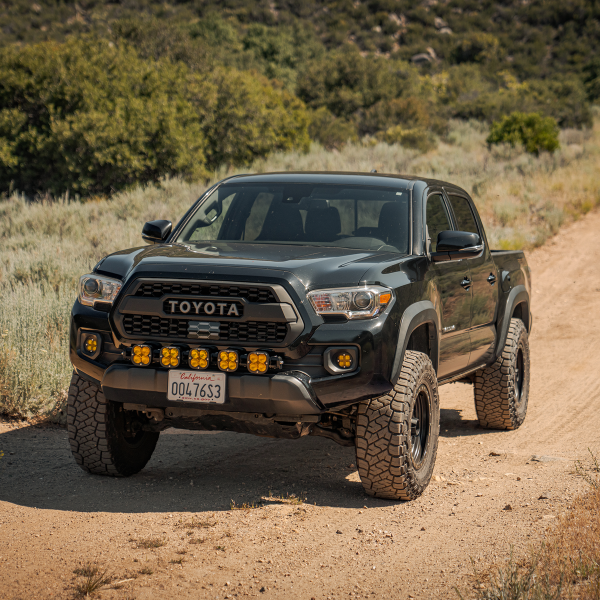 Toyota Tacoma with Dirt King billet upper control arms on trail