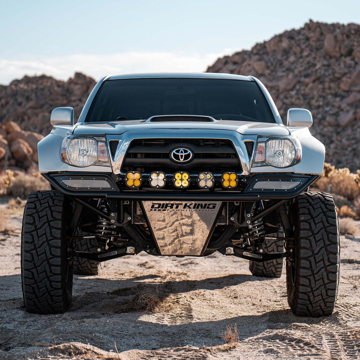 Toyota Tacoma with Dirt King long travel kit — front view