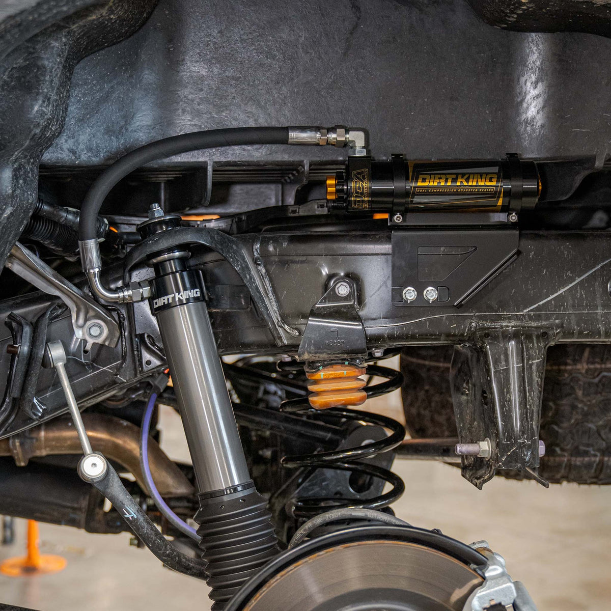 Dirt King DCA rear shock reservoir installed on Toyota Tacoma