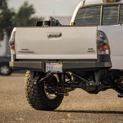 Dirt King plate rear bumper installed angle view on Toyota Tacoma