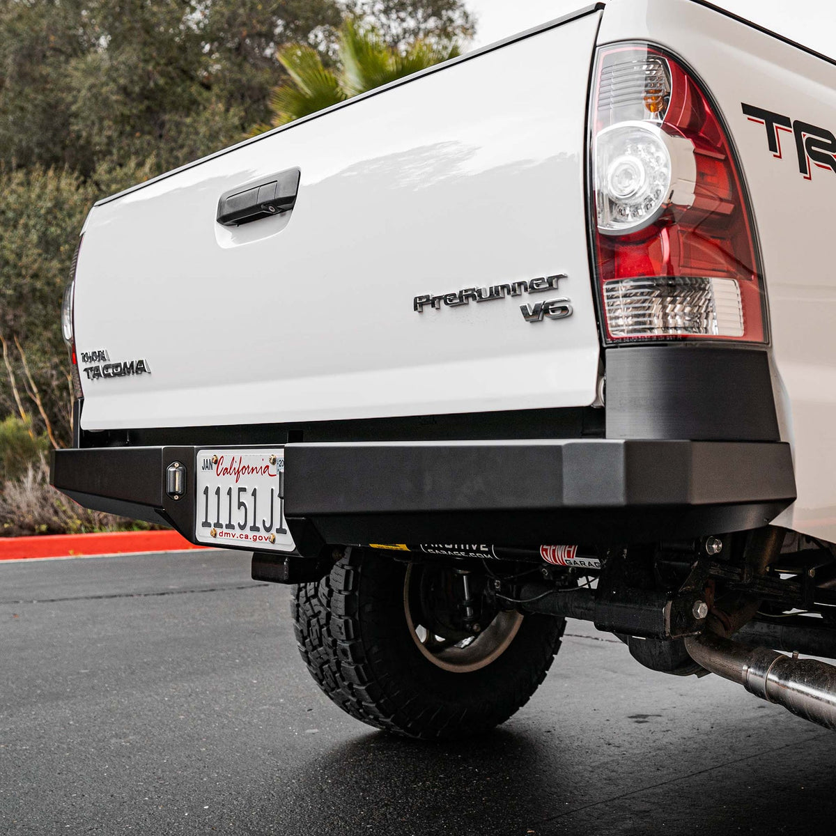 Dirt King plate rear bumper installed side view on Toyota Tacoma